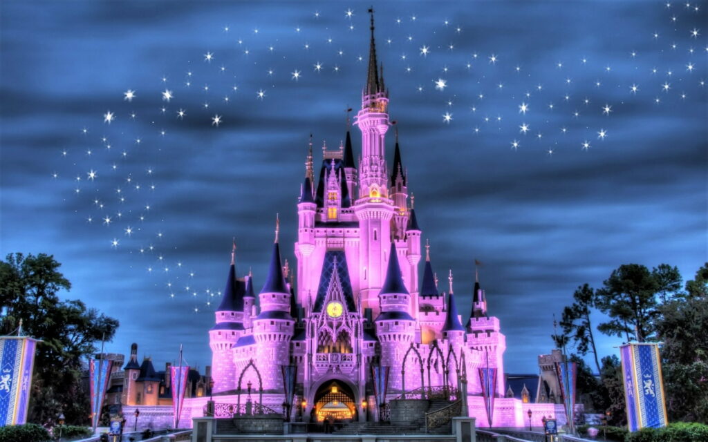 Disney Cinderella Castle glowing pink with sparkling fairy dust against twilight sky HD wallpaper