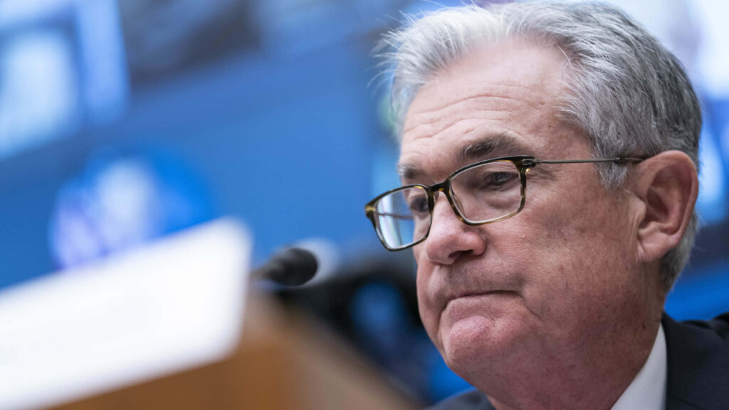 Distinguished gray-haired man with glasses deep in discussion in formal setting close-up Wallpaper