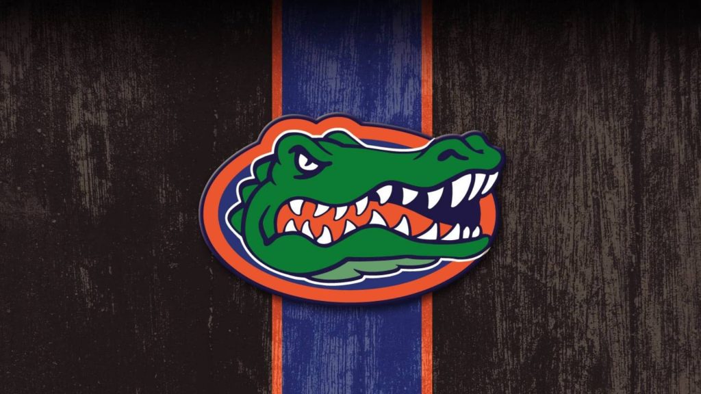 Distressed Florida Gators logo with angry alligator mascot on dark textured vintage wallpaper