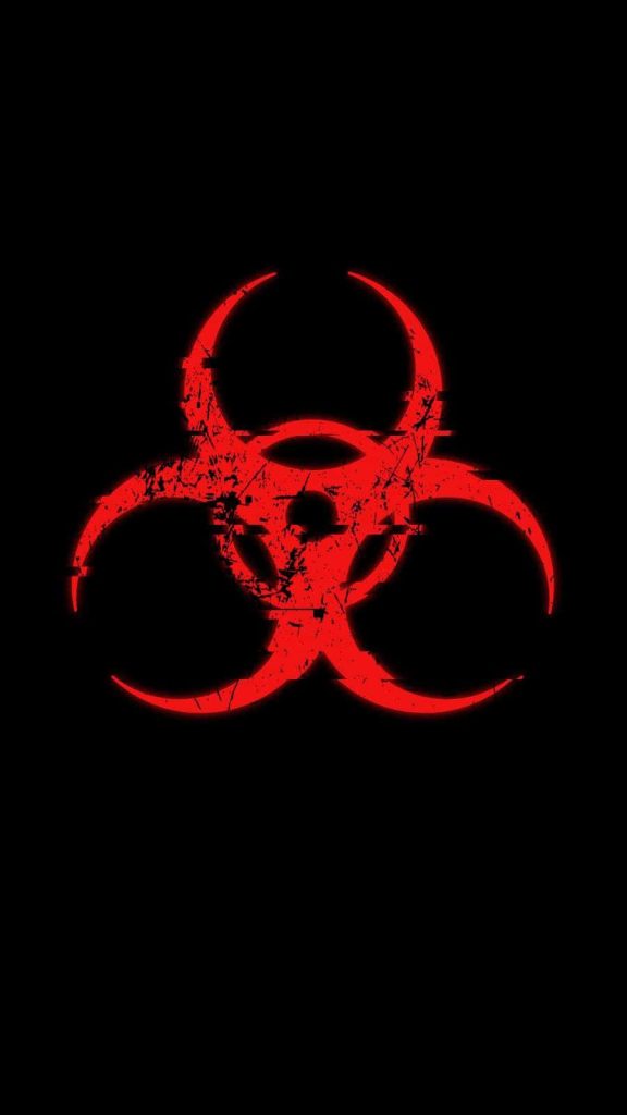 Distressed glowing red biohazard symbol on black grunge textured wallpaper background