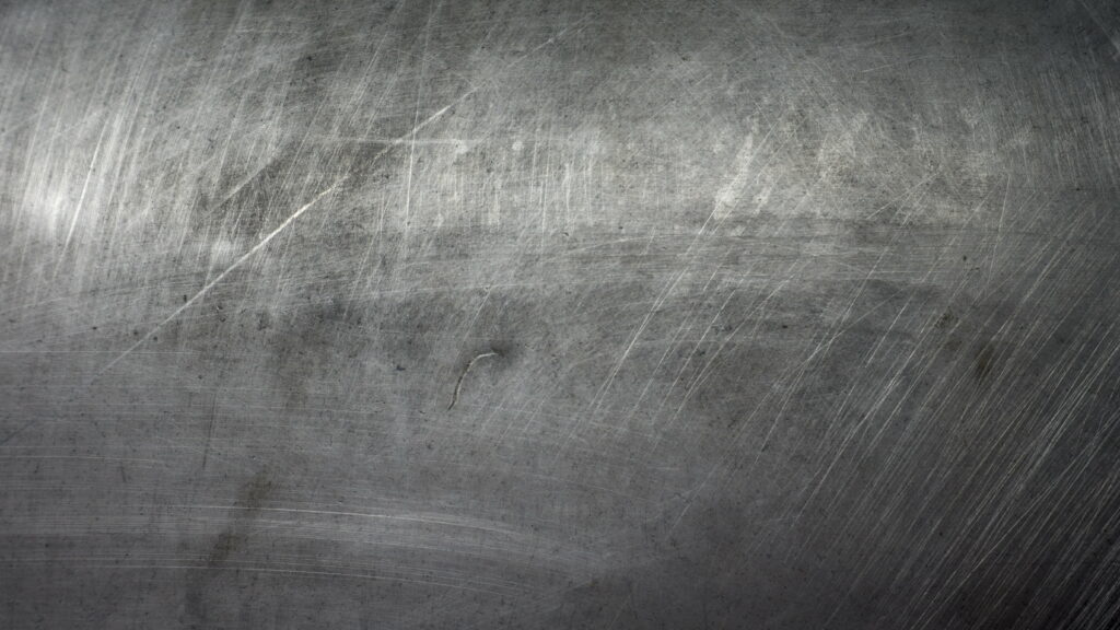 High-resolution distressed metal texture wallpaper with realistic scratches industrial gray surface