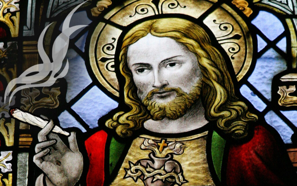 Sacred Mary Jane: A Colorful Stained Glass Depiction of Jesus Enjoying Cannabis Wallpaper