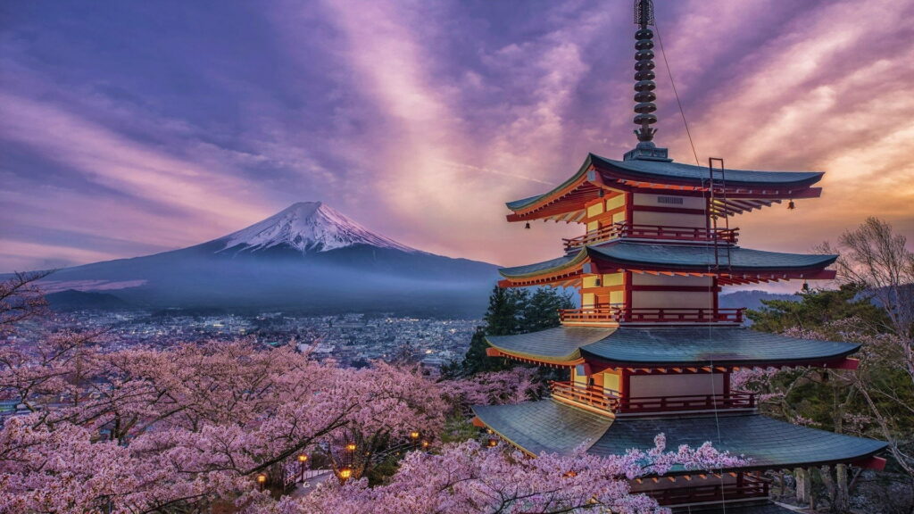 Red Chureito Pagoda and pink cherry blossoms with Mount Fuji at sunset under purple sky wallpaper