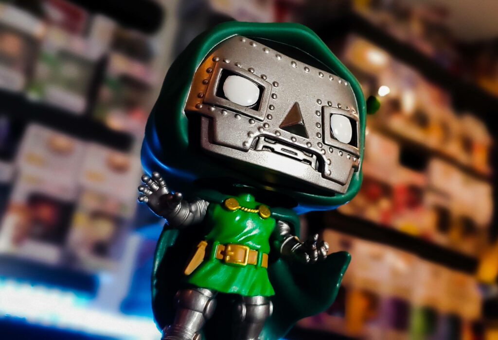 Doctor Doom collectible figure wallpaper with metal mask green hood and detailed armor background