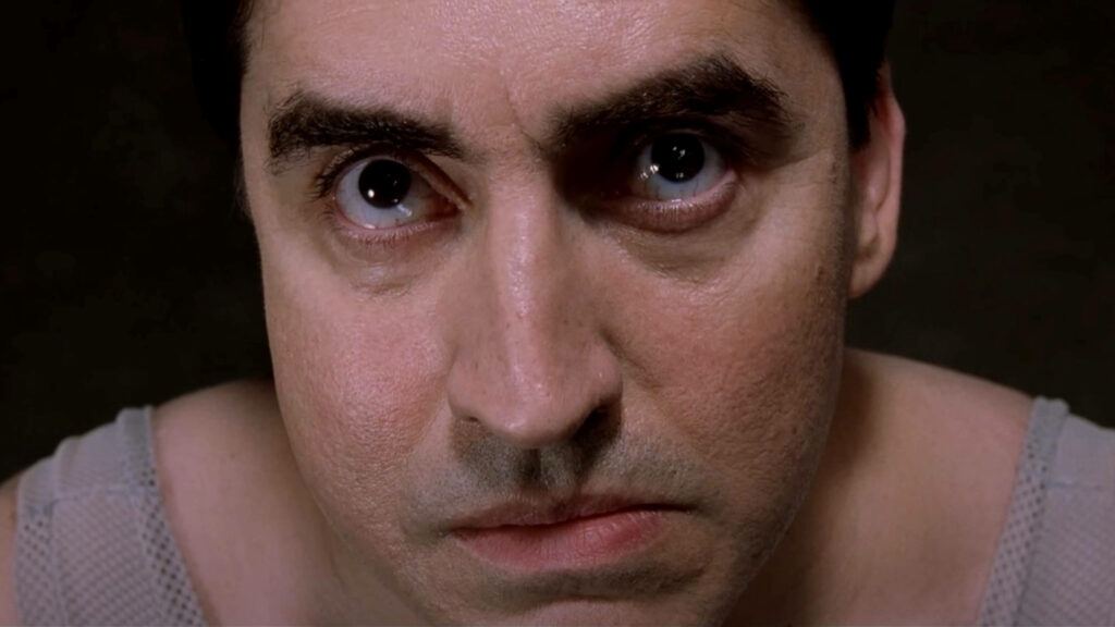 Alfred Molina as Doctor Octopus intense close-up with dramatic lighting and sharp facial details Wallpaper