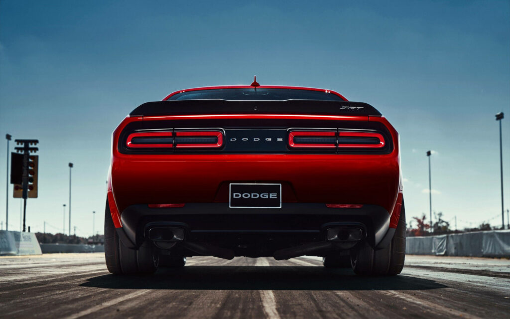 Red Dodge Challenger Demon rear view on drag strip with muscular stance and wide tires wallpaper