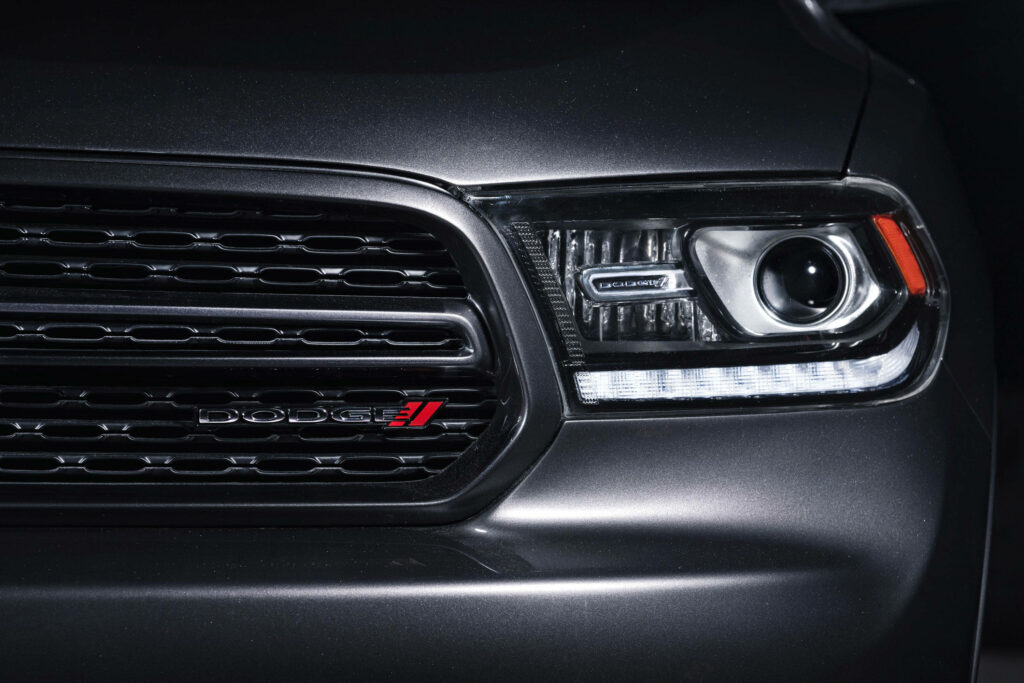 Close up of Dodge Durango headlight and grille with LED accents and sleek metallic finish wallpaper