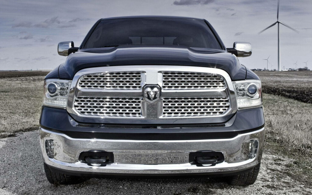 Dodge Ram front view with chrome grille and headlights against rural wind turbines wallpaper background