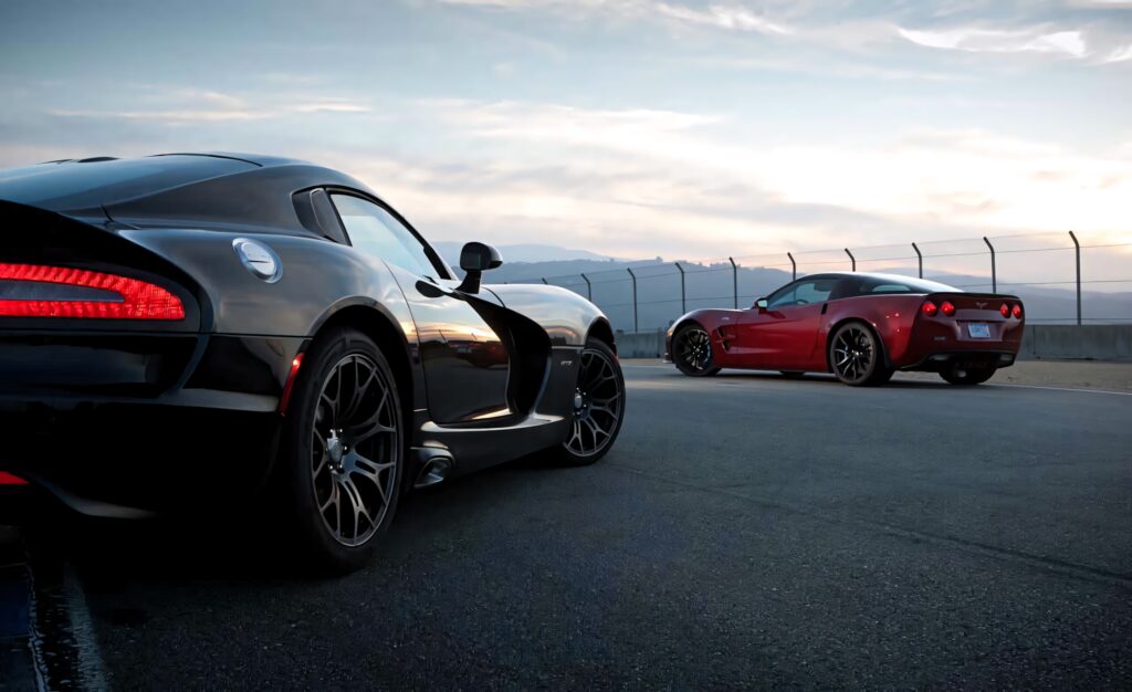 Black and red Dodge Vipers racing at dusk showcasing sleek curves and muscular design wallpaper