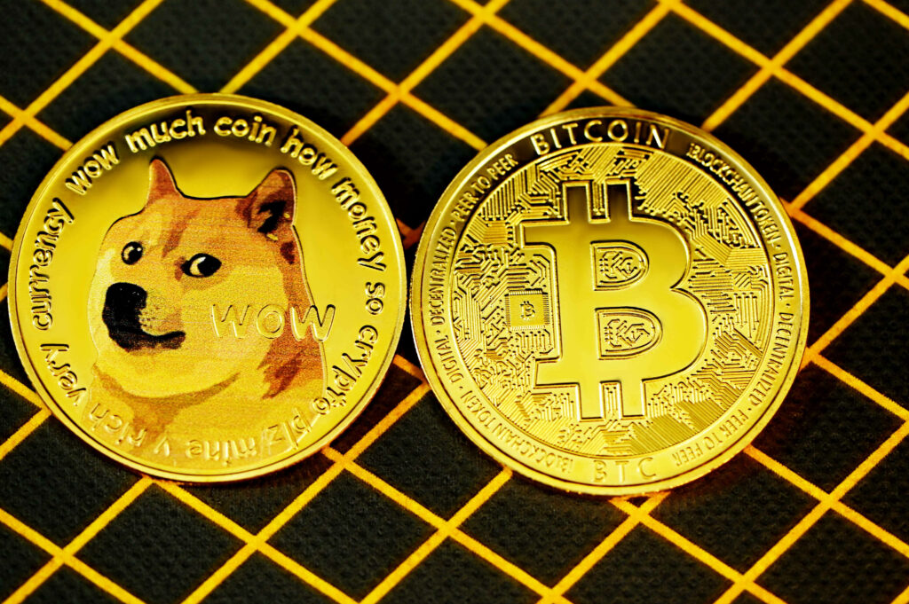 Dogecoin and Bitcoin coins side by side on black background with yellow grid lines wallpaper