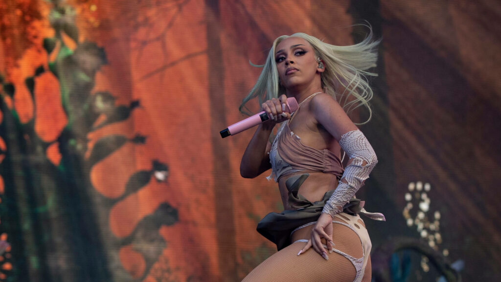 Doja Cat Hair Flick Wallpaper: Dynamic Stage Performance Background
