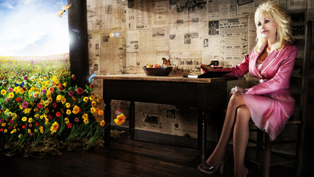 Dolly Parton seated by vintage wooden desk surrounded by vibrant flowers and nostalgic wallpaper