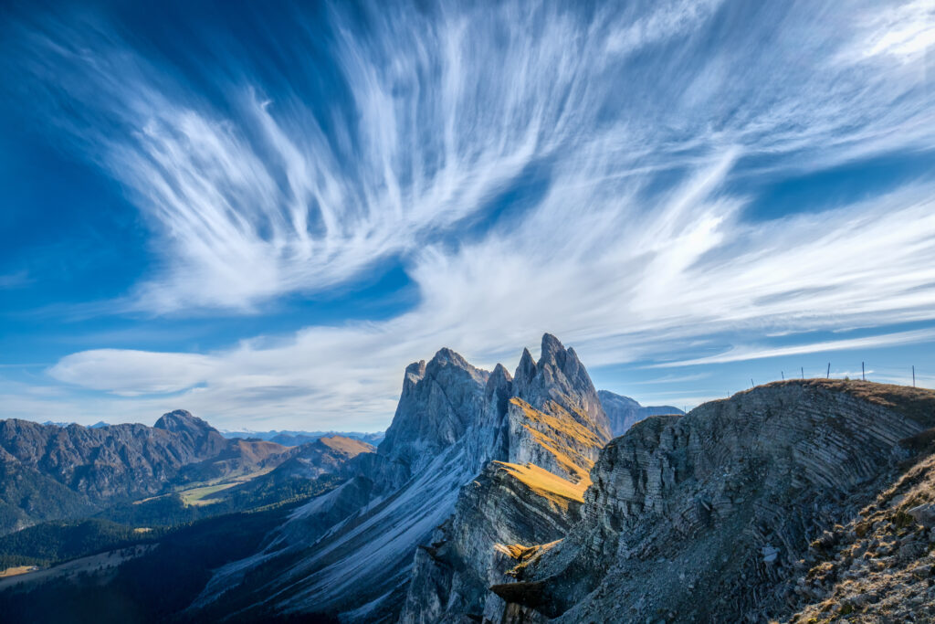 Dolomites Italy dramatic cliffs jagged peaks vivid blue sky wispy clouds mountain landscape wallpaper