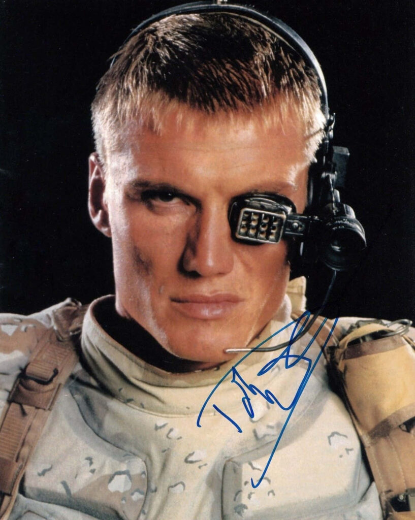 Dolph Lundgren action hero wallpaper with intense gaze military gear futuristic eyepiece background