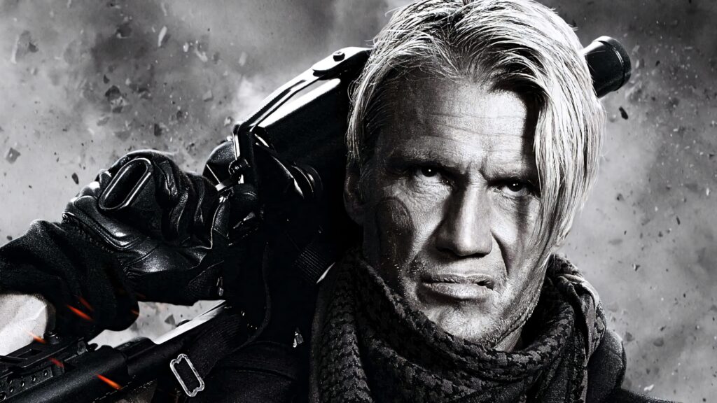 Dolph Lundgren intense action pose with tactical gear and heavy weapon on gritty background wallpaper
