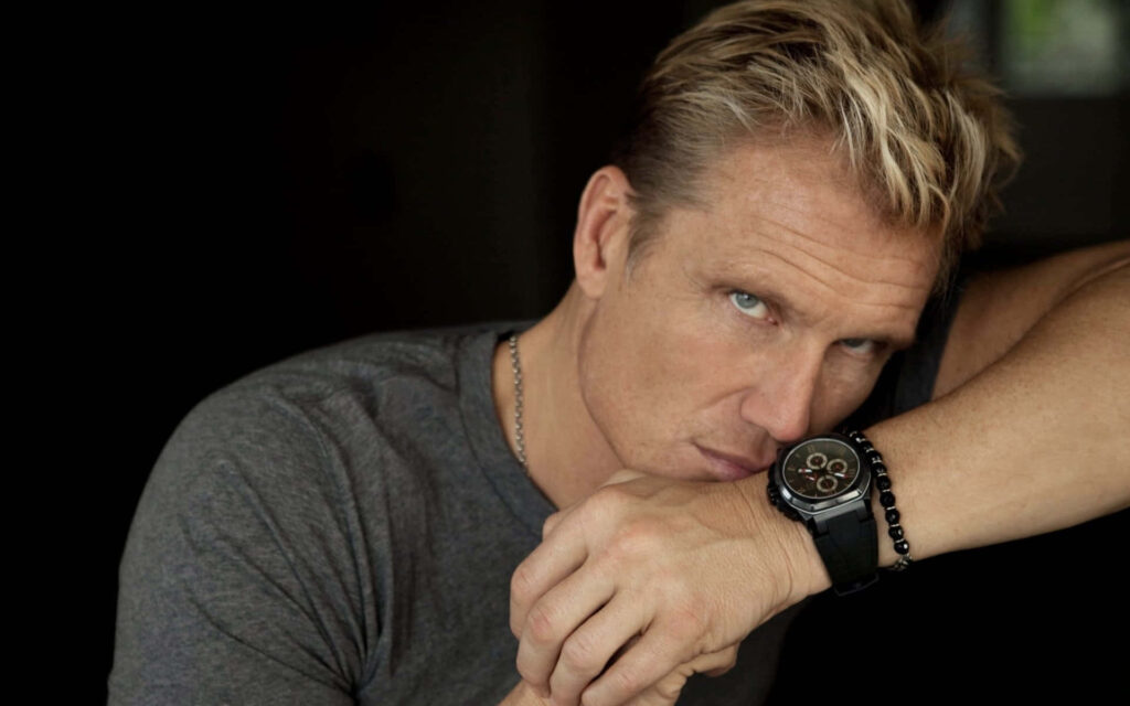 Dolph Lundgren intense portrait with rugged features and natural light on dark minimalist background Wallpaper