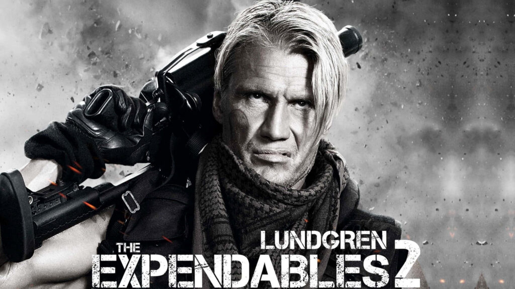 Dolph Lundgren Expendables 2 wallpaper gritty monochrome battle pose smoky action background