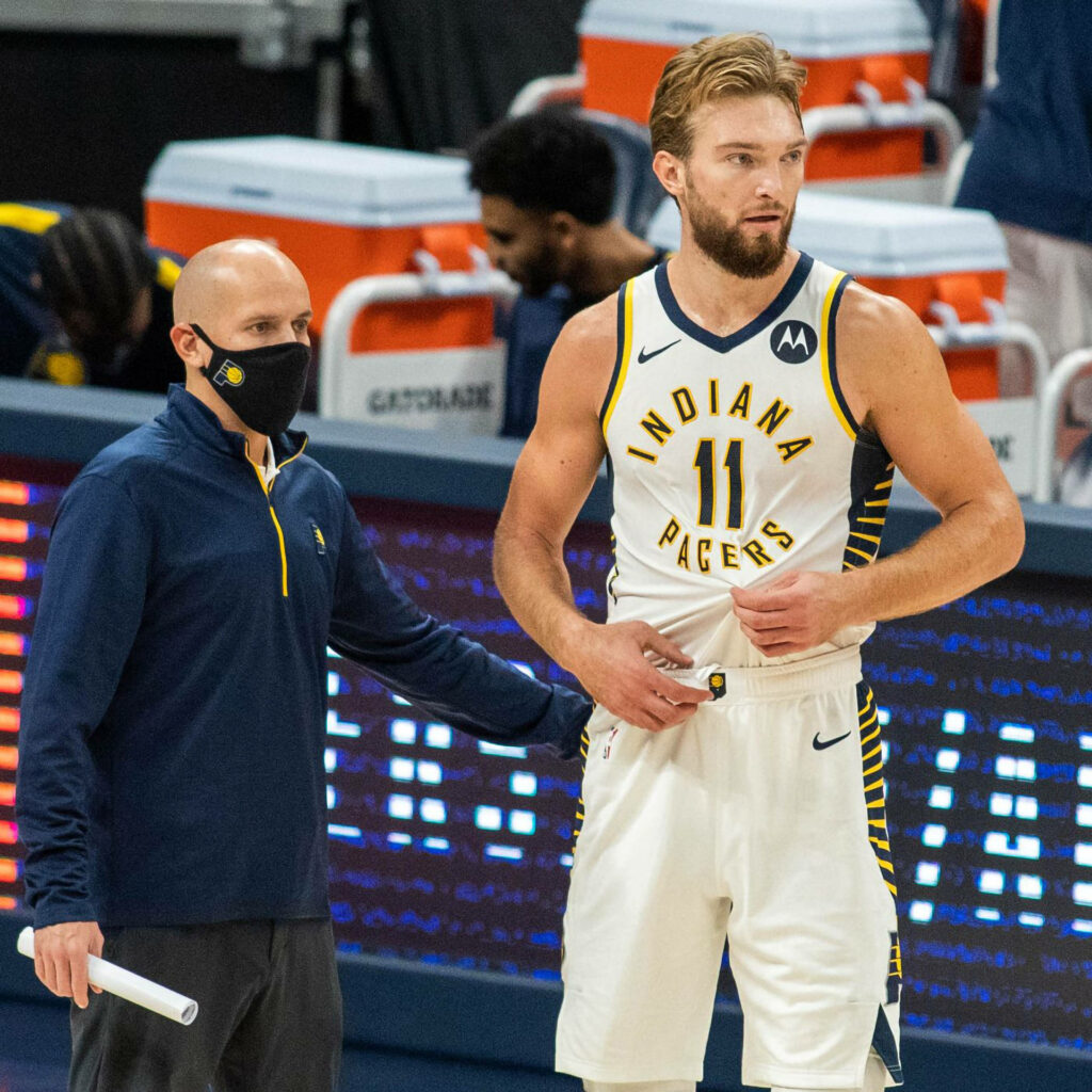 Domantas Sabonis in Indiana Pacers uniform courtside with coach showing teamwork and focus Wallpaper