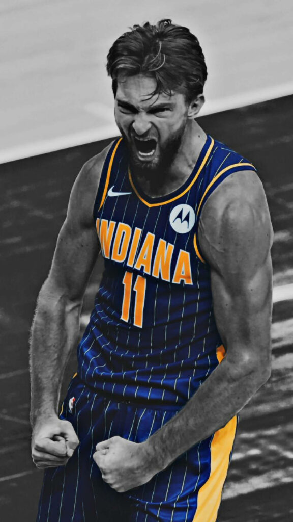 Domantas Sabonis in vibrant Indiana Pacers jersey with color splash on dramatic black and white background Wallpaper
