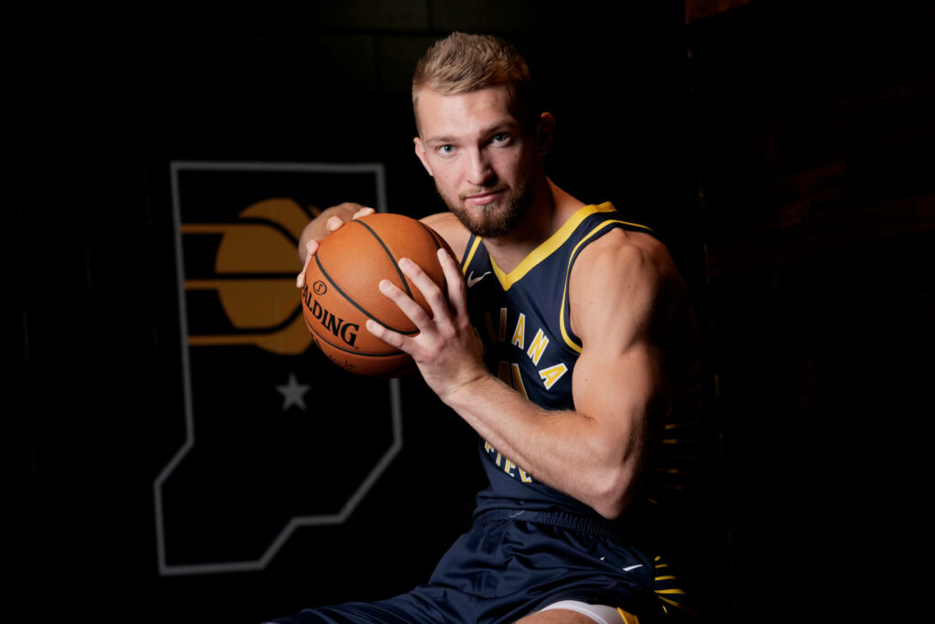 Domantas Sabonis Indiana Pacers holding basketball focused pose dark background sports portrait Wallpaper