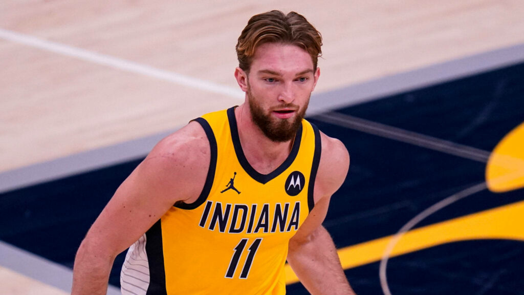 Domantas Sabonis in Indiana Pacers jersey with slicked-back hair on dynamic basketball court background Wallpaper