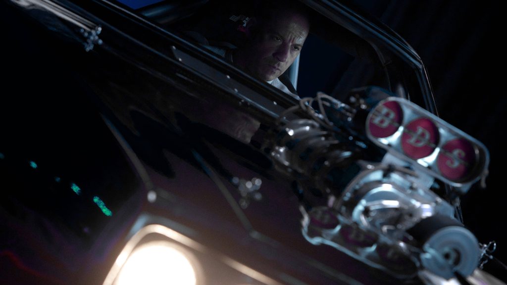 Vin Diesel as Dominic Toretto with muscle car and BDS supercharger in dramatic lighting wallpaper