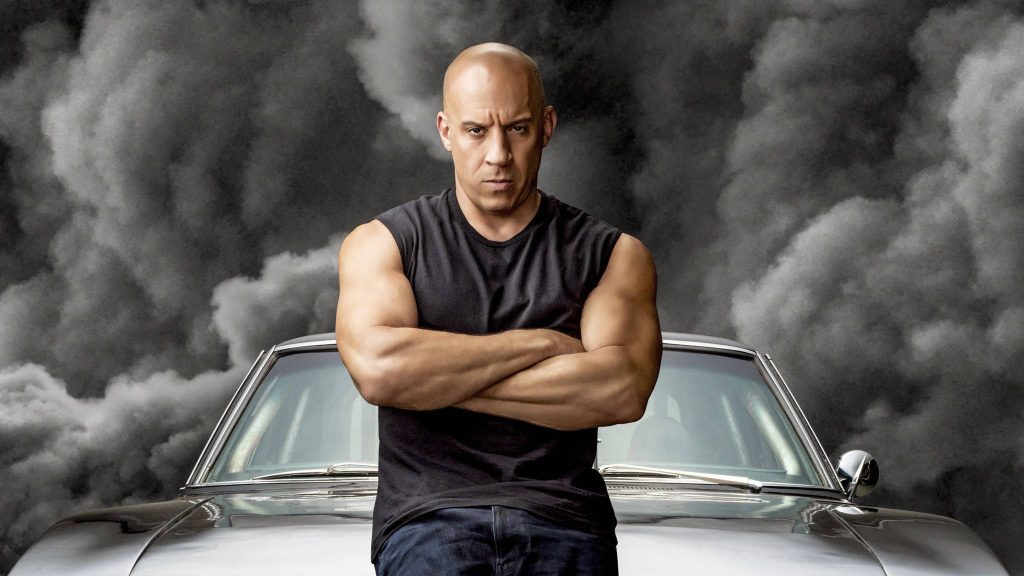 Vin Diesel as Dominic Toretto with silver muscle car and black smoke Fast and Furious wallpaper