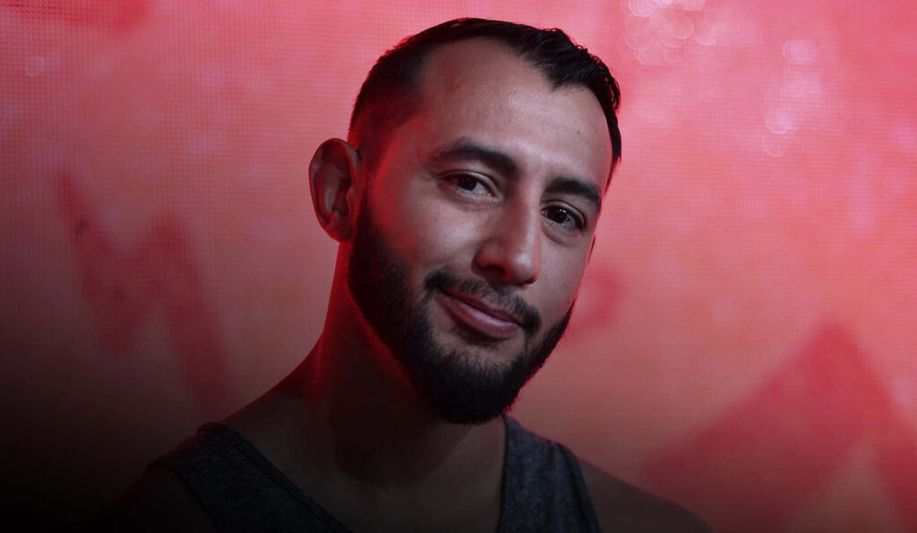 Dominick Reyes portrait wallpaper vibrant red background strong features athletic build