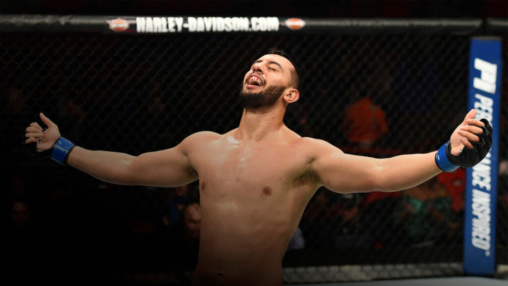 Dominick Reyes celebrates MMA victory in octagon with arms open dramatic lighting muscular form Wallpaper