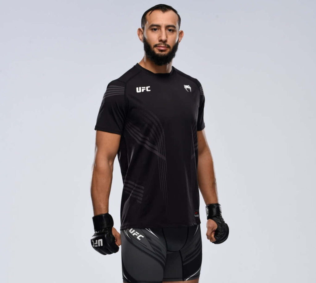 Dominick Reyes in UFC gear showing athletic physique ready for MMA fight on minimal background Wallpaper