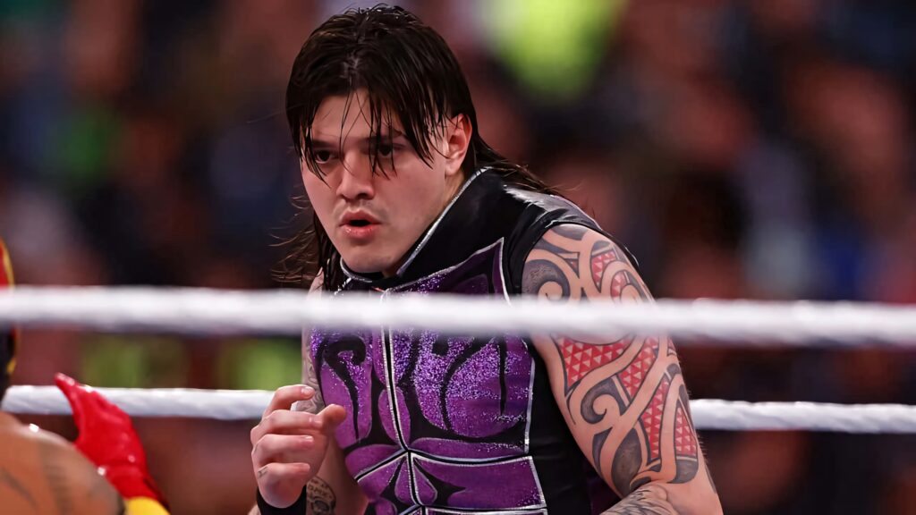 Dominik Mysterio wrestling action wallpaper with intense expression and purple black ring gear