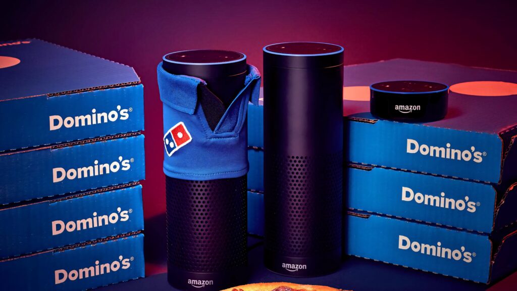 Dominos Pizza merchandise with blue boxes and Amazon Echo devices in red and blue wallpaper