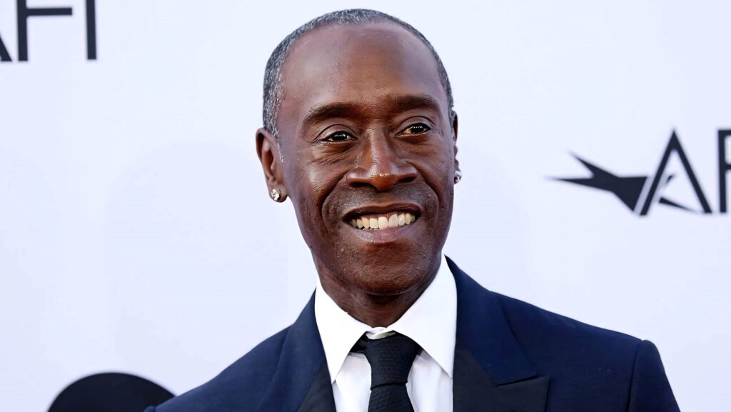 Don Cheadle at the Emmys in dark suit and tie with confident smile and elegant background wallpaper