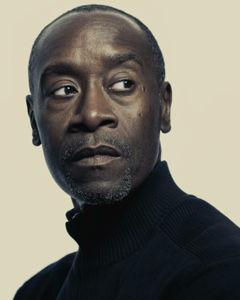Don Cheadle looking sideways in soft neutral light with contemplative expression cream background wallpaper