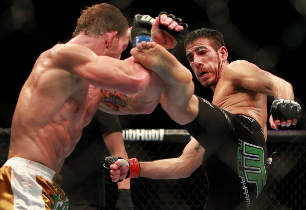 Donald Cowboy Cerrone delivers high kick to Dennis Siver in intense UFC Octagon fight action Wallpaper