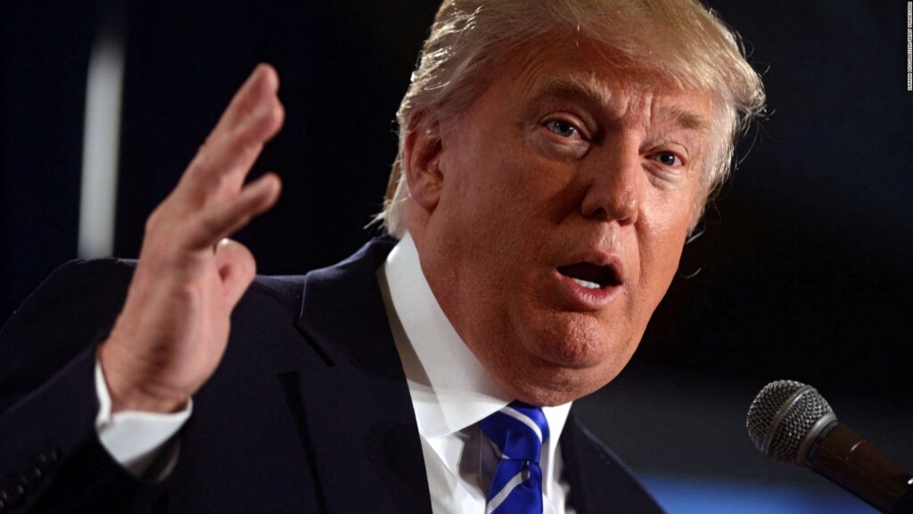 Donald Trump speaking passionately with expressive gesture and focused face in close-up wallpaper