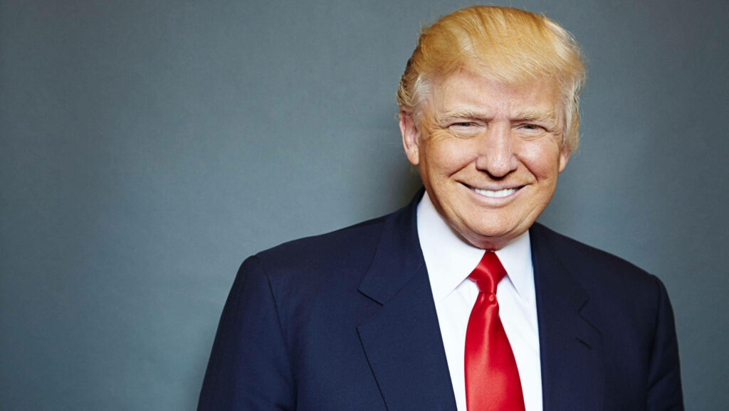 Donald Trump smiling confidently in navy suit red tie high-resolution gray background wallpaper
