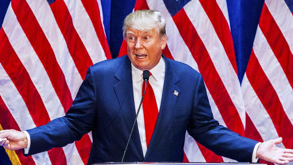 Donald Trump surprised expression in suit red tie with vibrant American flags patriotic wallpaper background