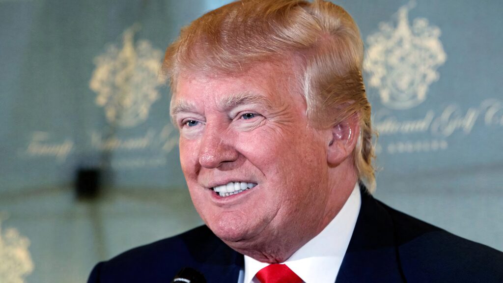 Donald Trump with kind smile warm tones elegant blurred background high resolution wallpaper