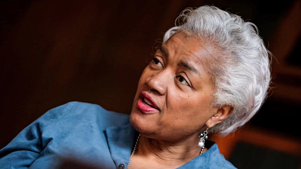 Donna Brazile speaking passionately with silver hair against warm background in inspiring portrait Wallpaper