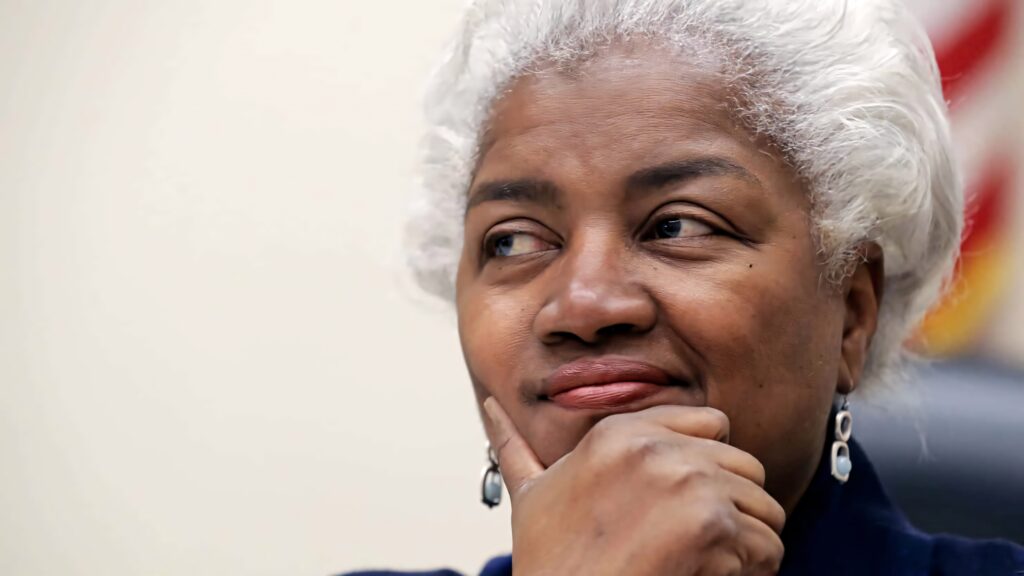 Donna Brazile thoughtful and engaged at speaking event with natural light highlighting silver hair Wallpaper