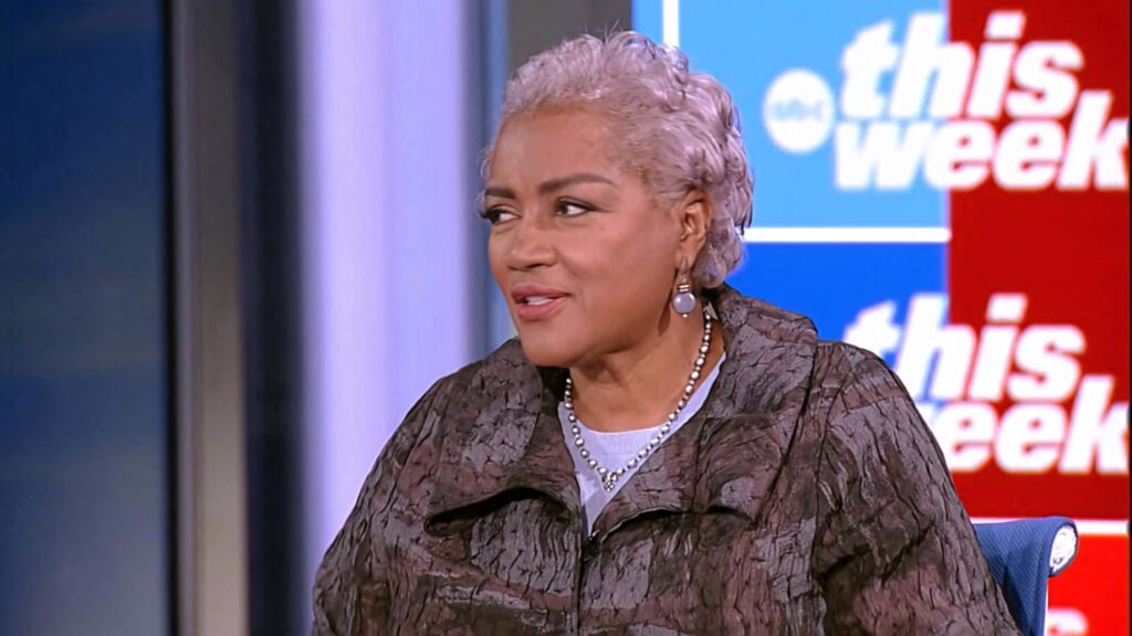 Donna Brazile speaking at This Week event wearing brown jacket with red and blue banner backdrop Wallpaper