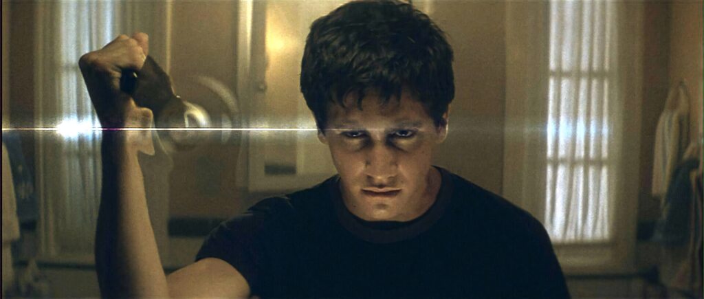 Donnie Darko intense moody wallpaper dimly lit room dramatic shadows psychological atmosphere