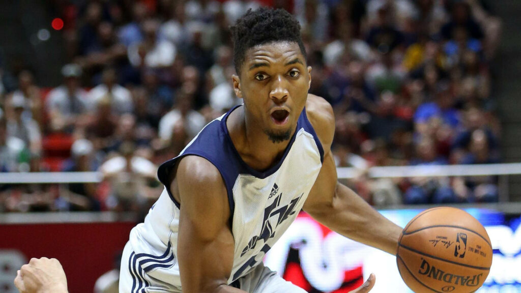 Donovan Mitchell intense basketball action vibrant arena dynamic professional game wallpaper