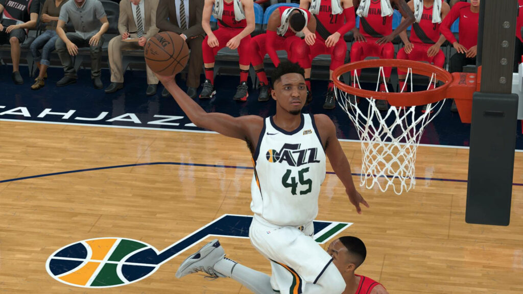 Donovan Mitchell mid dunk Utah Jazz NBA game vibrant court intense crowd high energy basketball action Wallpaper