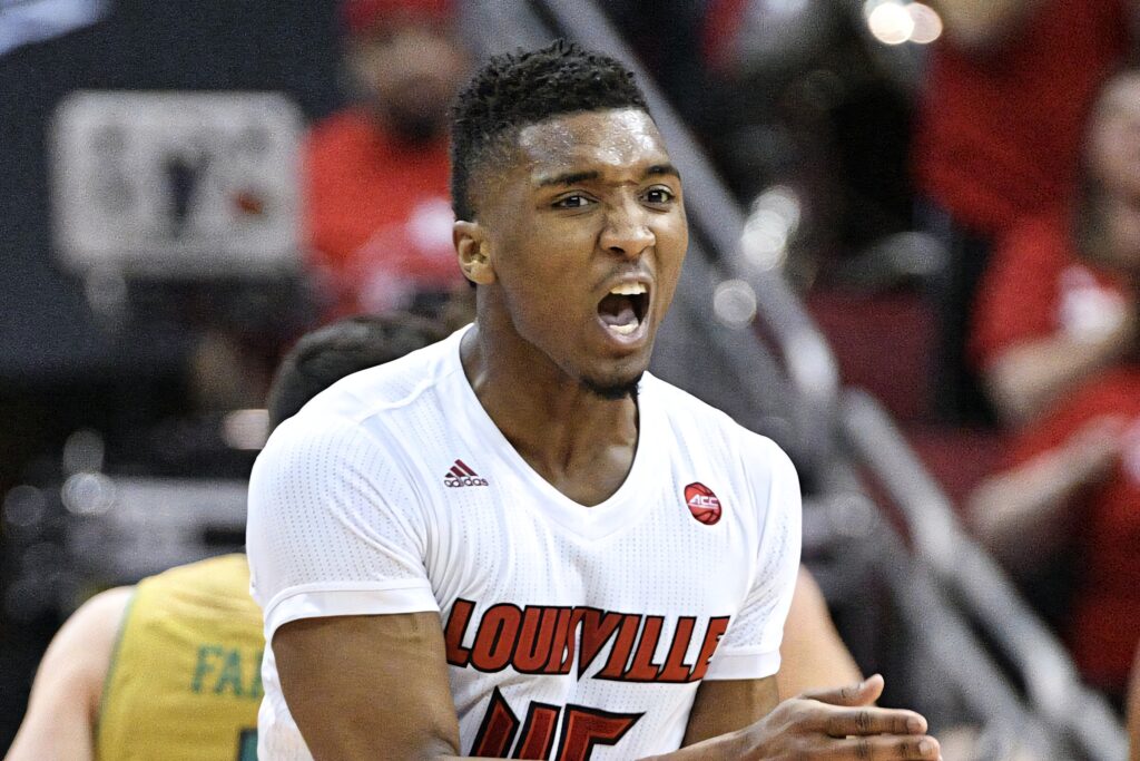 Donovan Mitchell intense Louisville basketball game action vibrant crowd energy wallpaper background