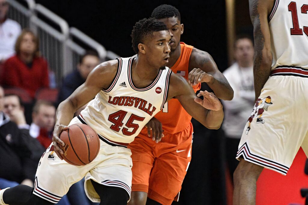 Donovan Mitchell in Louisville basketball jersey driving past defenders dynamic college game action Wallpaper