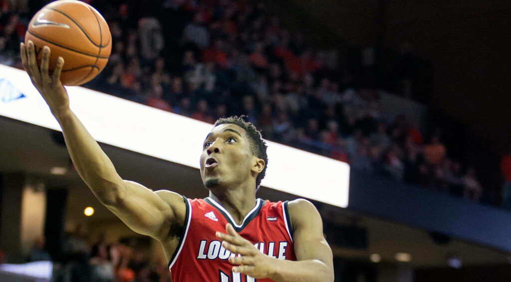 Donovan Mitchell in Louisville jersey driving for a layup dynamic basketball action wallpaper
