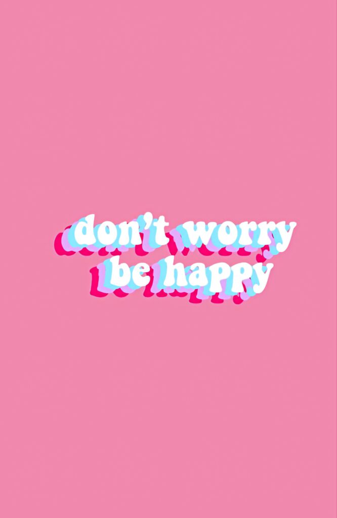 Minimalist pink wallpaper with bold white and blue text saying dont worry be happy positivity message