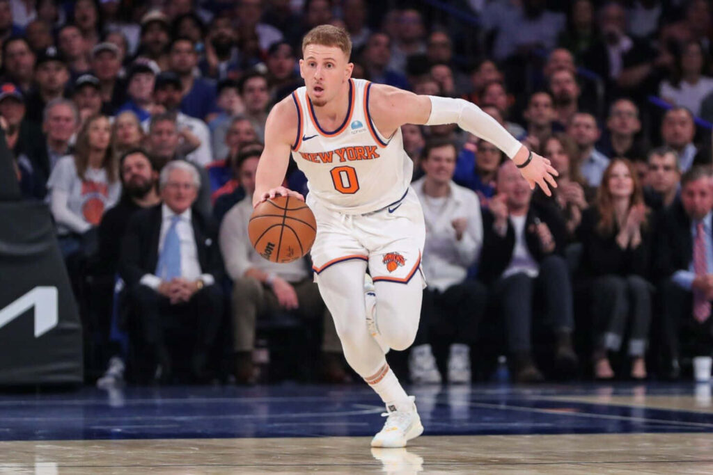 Donte DiVincenzo dribbling in New York Knicks uniform dynamic basketball action wallpaper